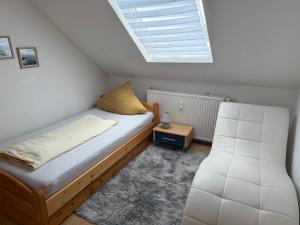 a small bedroom with a bed and a skylight at Zentral Z in Siegen