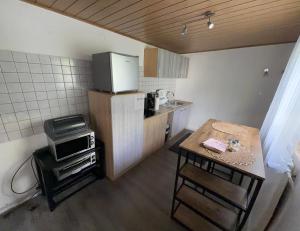 a small kitchen with a table and a microwave at Zentral Z in Siegen