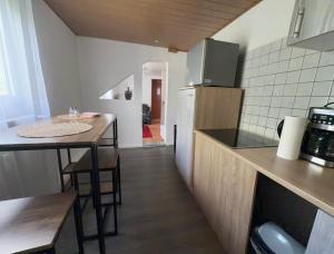 a kitchen with a counter and a table with chairs at Zentral Z in Siegen +5 photos
