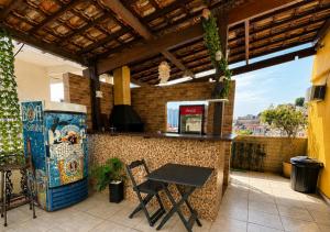 a patio with a table and a drink cooler at Apartamentos Porto Maravilha in Rio de Janeiro