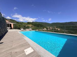a swimming pool with a view of a mountain at House Over The Paradise in Moneglia