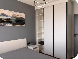 a bedroom with a bed and a book shelf at Apartamenty Zator Jaśminowa in Zator