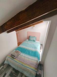 a small bedroom with a bed in a attic at Casa Calera in Nerja