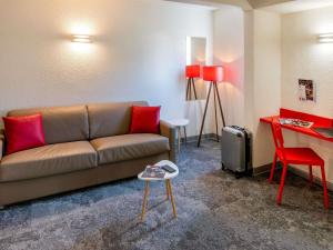 a living room with a couch and a table at ibis Styles Cannes Le Cannet in Cannes