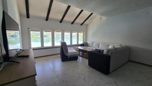 a living room with a couch and a table at Captains Seherzada Apartment in Železnička Stanica Ostrožac