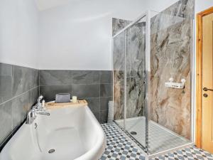 a bathroom with a shower and a white bath tub at 4 Bed in Forton oc-81290 in Forton +23 photos