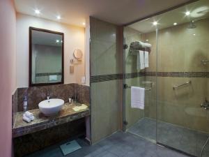 a bathroom with a sink and a shower at Novotel Suites Riyadh Olaya in Riyadh +84 photos