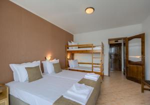 a bedroom with two beds and a bunk bed at Hotel Feniks Lozenets in Lozenets