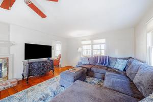 a living room with a couch and a flat screen tv at Brevard Bungalow in Brevard