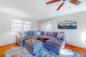 a living room with a couch and a ceiling fan at Brevard Bungalow in Brevard