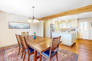 a kitchen and dining room with a wooden table and chairs at Brevard Bungalow in Brevard +21 photos