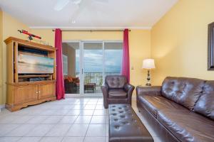 a living room with a couch and a television at The Dunes 503 in Gulf Shores +26 photos
