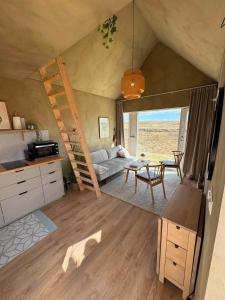 a living room with a couch and a table at Cozy cottage with a view in Hella
