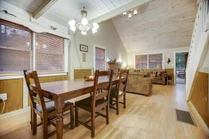 a dining room and living room with a wooden table and chairs at Along the River Cottage in Cullowhee