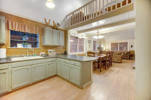 a kitchen with a sink and a dining room at Along the River Cottage in Cullowhee +15 photos