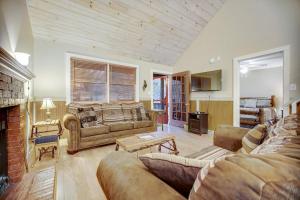 a living room with a couch and a fireplace at Along the River Cottage in Cullowhee