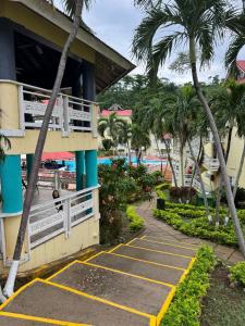 a resort with palm trees in front of a building at Mystic Ridge Ochi in Ocho Rios +1 photo