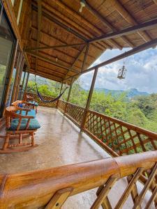 a balcony of a house with a table and chairs at Cabaña ALAK in La Vega
