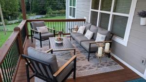 a porch with chairs and a couch and a table at Blueridge Brew View in Fairview