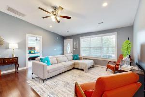 a living room with a couch and a ceiling fan at Blueridge Brew View in Fairview +24 photos