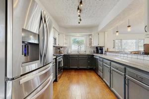 a large kitchen with stainless steel appliances and wooden floors at Casa Amarilla in Arden