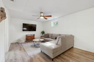 a living room with a couch and a ceiling fan at Casa Amarilla in Arden +15 photos