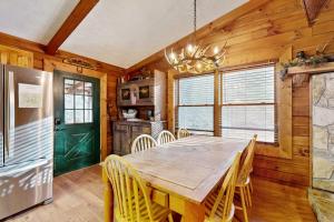 a dining room with a wooden table and chairs at Moose Creek Lodge in Sylva