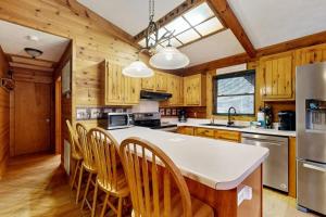 a kitchen with wooden cabinets and a white counter top at Moose Creek Lodge in Sylva