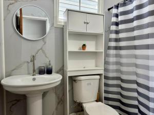 a bathroom with a sink and a toilet and a mirror at Babus Villas del Sol in El Combate +17 photos