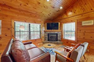 a living room with a couch and a fireplace at Happy Top Hideaway in Bryson City