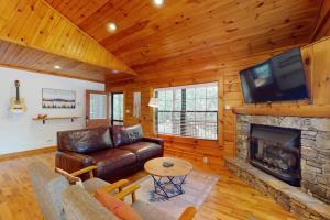 a living room with a couch and a fireplace at Happy Top Hideaway in Bryson City