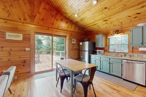 a kitchen with a table and chairs in a cabin at Happy Top Hideaway in Bryson City