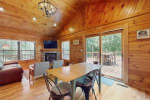 a dining room and living room with a table and chairs at Happy Top Hideaway in Bryson City +13 photos