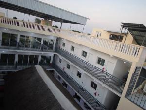an aerial view of a white building with balconies at Ndjuly Residencial in Luanda