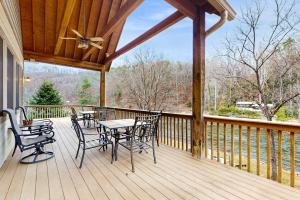 a wooden deck with a table and chairs on it at Tuckaway Retreat in Sylva