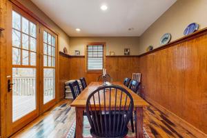 a dining room with a wooden table and chairs at Tuckaway Retreat in Sylva