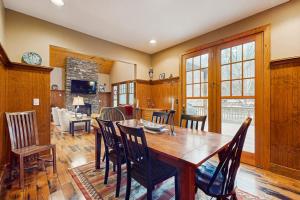 a kitchen and dining room with a wooden table and chairs at Tuckaway Retreat in Sylva +28 photos