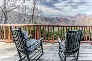 two rocking chairs sitting on a deck with a view at Cloud Walk in Sylva