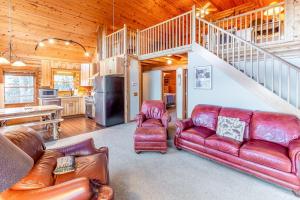 a living room with a couch and a staircase at Cloud Walk in Sylva