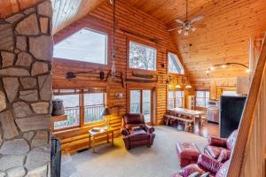 a large living room with a stone wall at Cloud Walk in Sylva +27 photos