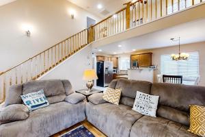 a living room with a couch and a staircase at Full Stream Ahead in Whittier
