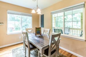 a dining room with a wooden table and chairs at Full Stream Ahead in Whittier