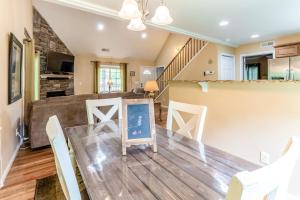 a dining room and living room with a table and chairs at Full Stream Ahead in Whittier +26 photos