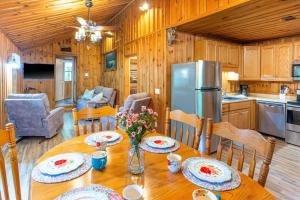a kitchen and dining room with a table and a refrigerator at The Outpost in Whittier