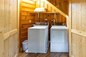 a utility room with two washing machines in a cabin at The Outpost in Whittier +7 photos