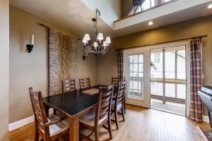 a dining room with a black table and chairs at Above the River in Sylva