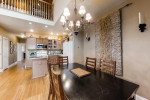 a kitchen and dining room with a table and chairs at Above the River in Sylva +25 photos
