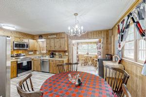 a kitchen with a table and chairs in a kitchen at The Little Dude Cabin in Franklin