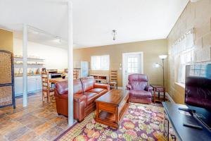 a living room with a leather couch and a table at Cozy Mountain Hideaway in Waynesville