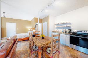 a kitchen and living room with a table and a couch at Cozy Mountain Hideaway in Waynesville